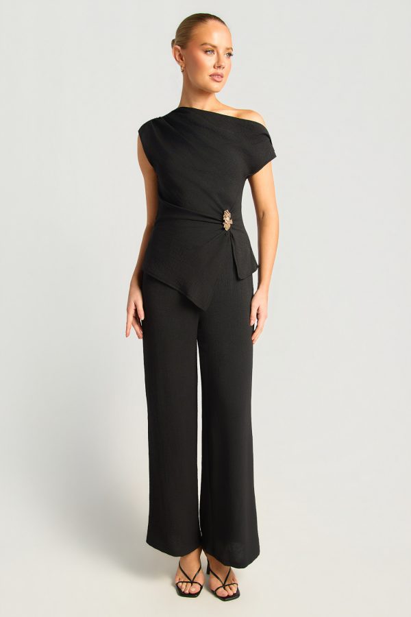 KoKo Aurelia black asymmetric top and pants set with gold waist buckle and relaxed wide leg pants