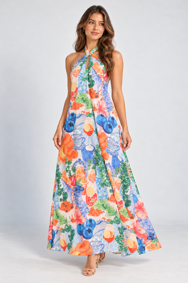 KoKo Amalfi Maxi Dress with a crossover halter neckline and colourful citrus, floral and blue ceramic print, shown on a model
