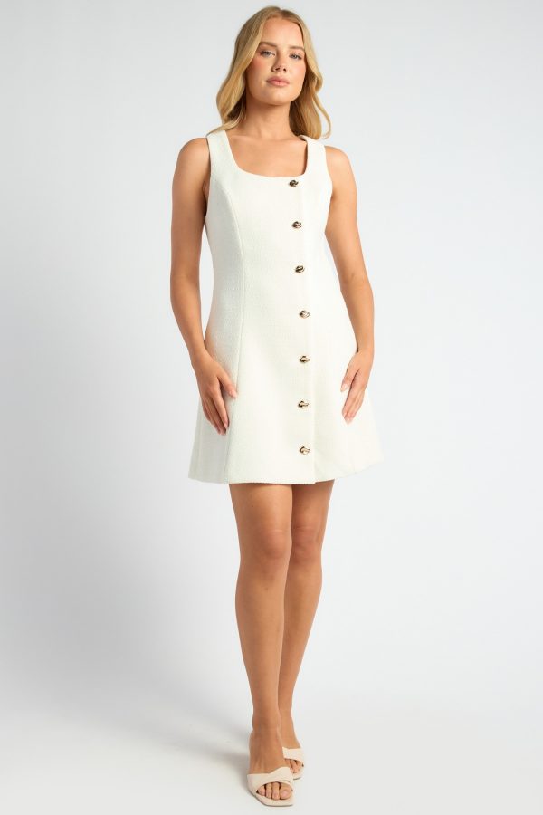 KoKo Estelle cream tweed mini dress with a sleeveless square neckline, gold-tone front buttons and a gently flared skirt, shown on a model