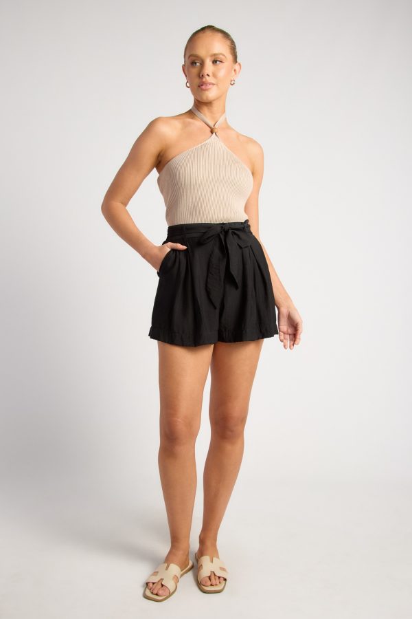 KoKo Margot black high-waisted rayon blend shorts with front pleats, wide legs and an included matching fabric tie belt, shown on a model