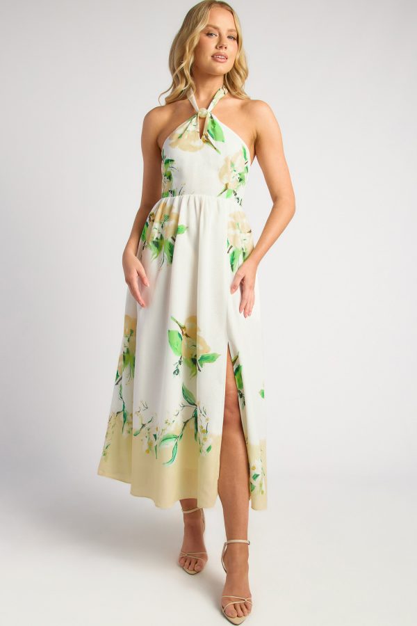 KoKo Marielle cream faux linen floral midi dress with a marble bead halter neckline, yellow blooms and green foliage, shown on a model